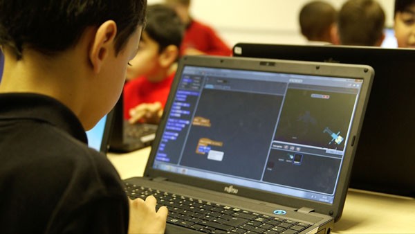 Boy coding on a laptop