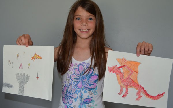 Kirks daughter holding up her drawings for the Fantasy Me tutorial