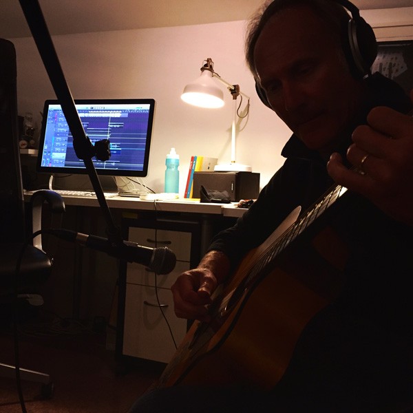 Mark playing guitar with the sound being recorded in the background